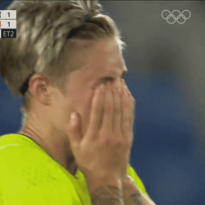 Person Covering Face With Hands Olympics Logo Behind GIF
