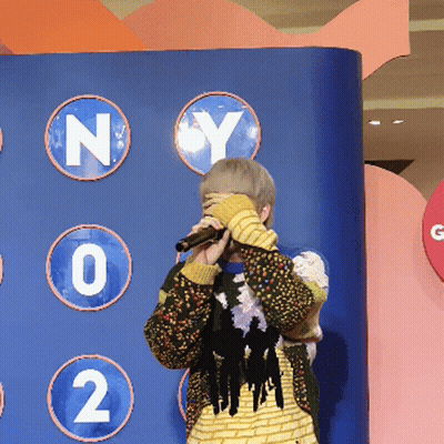 Person Covering Face With Microphone GIF