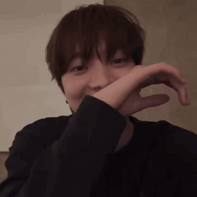 Person Covering Mouth In Dark Room GIF