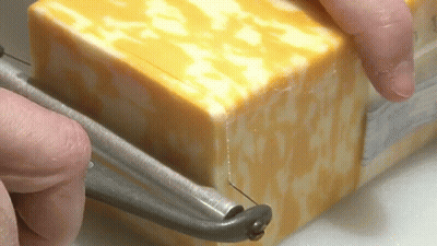 Person Cutting Cheese With Knife GIF