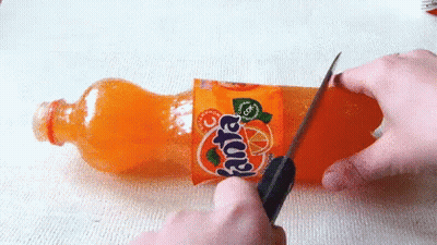 Person Cutting Fanta Bottle With Knife GIF