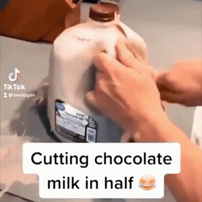 Person Cutting Gallon Of Milk In Half GIF