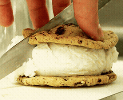 Person Cutting Ice Cream Sandwich With Knife GIF