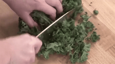 Person Cutting Kale With Knife GIF