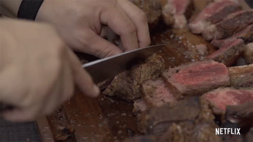 Person Cutting Large Piece Of Meat With Netflix GIF