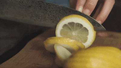 Person Cutting Lemon With Knife GIF