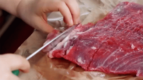 Person Cutting Meat With Knife GIF