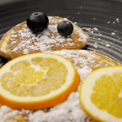 Person Cutting Pancake On Wooden Board GIF