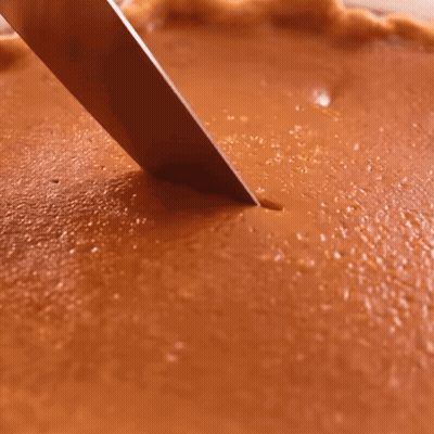 Person Cutting Pumpkin Pie With Knife GIF