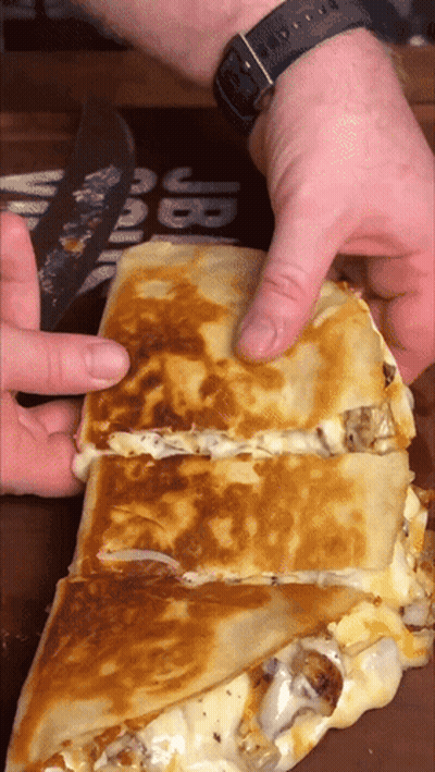 Person Cutting Quesadilla In Half GIF