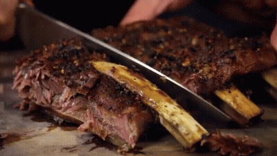 Person Cutting Ribs With Knife GIF