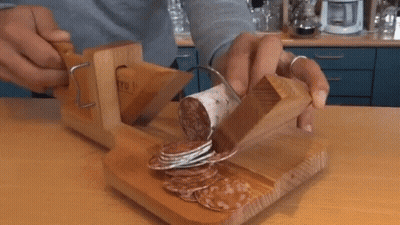Person Cutting Sausage On Wooden Board GIF