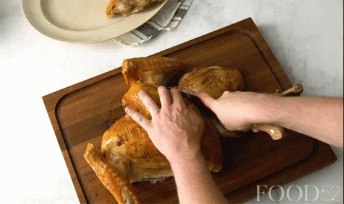 Person Cutting Turkey On Food52 Board GIF