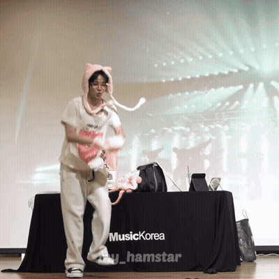 Person Dancing in Front of Music Korea Table