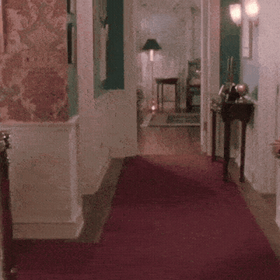 Person Dancing On Red Carpet In Hallway GIF