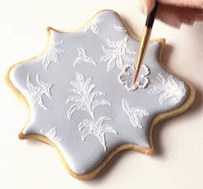 Person Decorating Cookie With Brush GIF