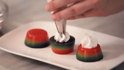 Person Decorating Dessert With Whipped Cream GIF