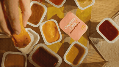 Person Dipping Chicken Nugget In Creamy Chili Sauce GIF