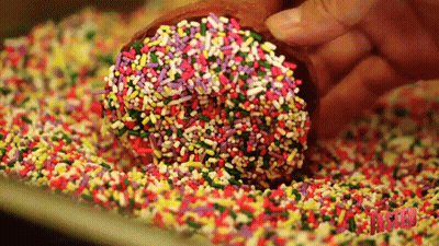 Person Dipping Donut In Sprinkles GIF
