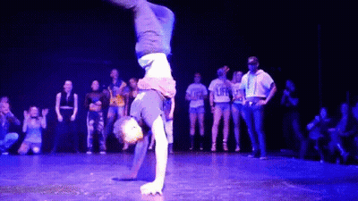 Person Doing Handstand In Front Of Group Wearing Life Shirts GIF