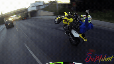 Person Doing Motorcycle Trick In Front Of Sum Shot Sign GIF