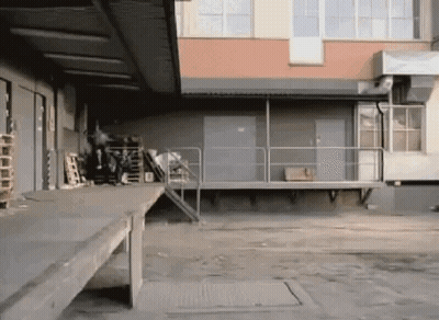 Person Doing Trick On Ramp In Warehouse GIF