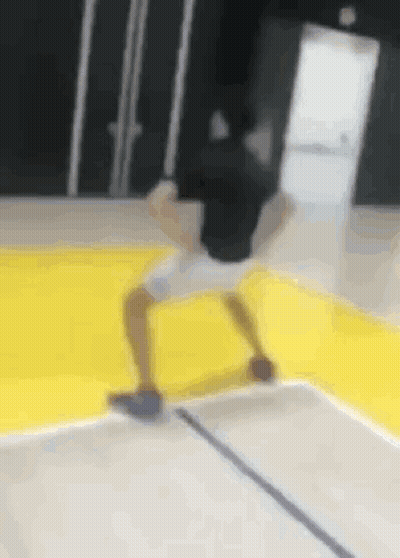 Person Doing Trick On Yellow Basketball Court GIF
