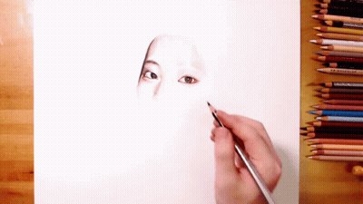 Person Drawing Woman Face With Colored Pencils GIF