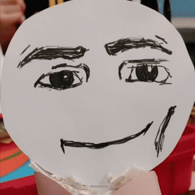 Person Drawn Face On Cupcake With Chocolate Chips GIF