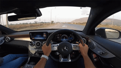Person Driving Mercedes With Logo On Steering Wheel GIF