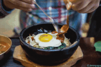 Person Eating Bowl Of Food With Spoon And Chopsticks GIF