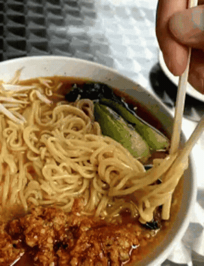Person Eating Noodles With Chopsticks In Soup Bowl GIF