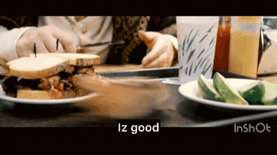 Person Eating Sandwich Next To Cucumbers GIF