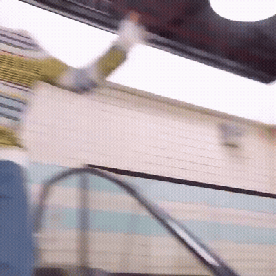 Person Falling Down Escalators In Front Of Building GIF