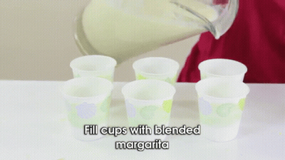 Person Filling Cups With Margarita GIF