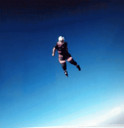 Person Flying In Blue Sky With Helmet GIF