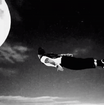 Person Flying In Front Of Full Moon GIF