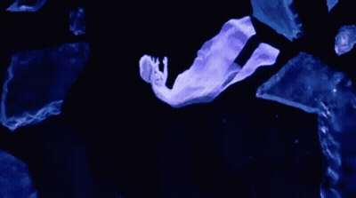 Person Flying Through Dark With Stick GIF