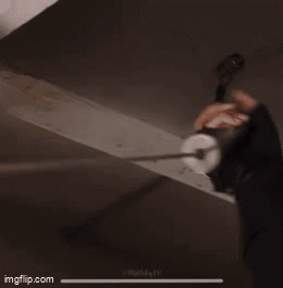 Person Hanging Wire from Ceiling