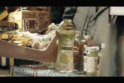 Person Holding 100% Natural Lemon Juice GIF