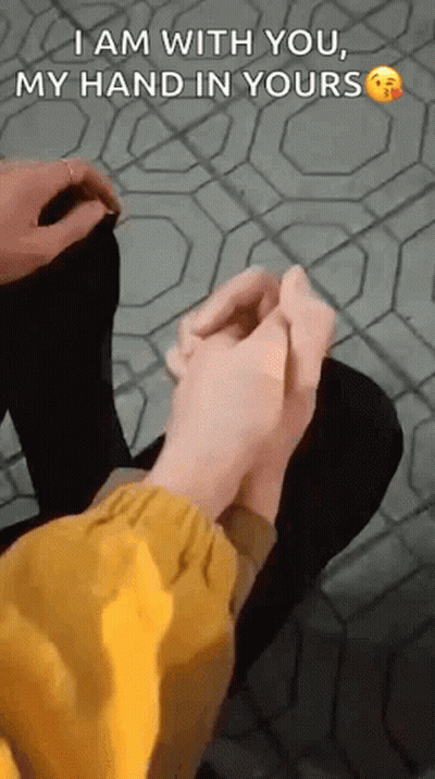 Person Holding Another's Hand Sitting On Tiled Floor GIF