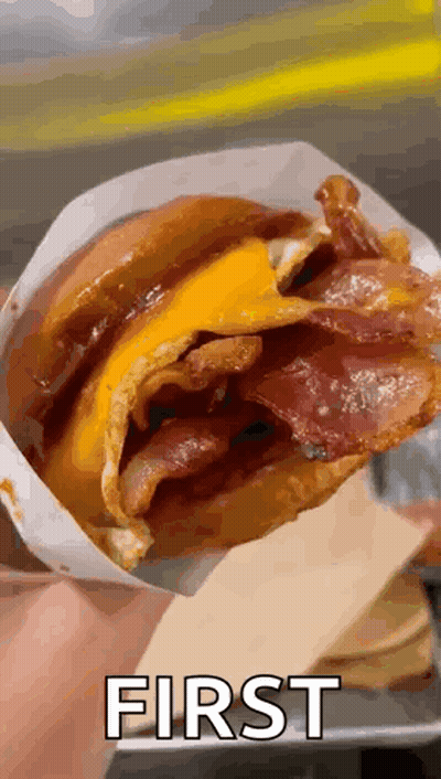 Person Holding Bacon Cheese Sandwich In Bag With First GIF
