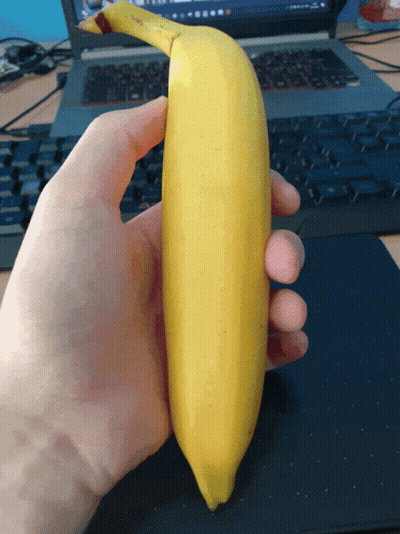 Person Holding Banana In Front Of Keyboard GIF