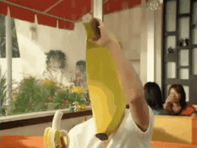 Person Holding Banana Over Head In Diner GIF