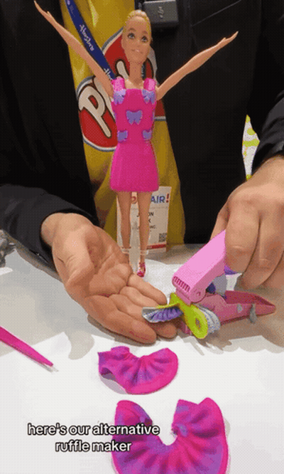 Person Holding Barbie Doll And Ruffle Maker GIF