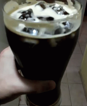 Person Holding Beer Glass With Ice Cubes GIF