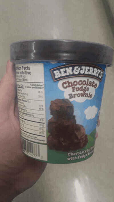 Person Holding Ben & Jerry's Chocolate Fudge Brownie GIF