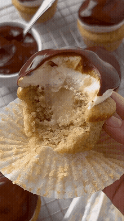 Person Holding Bitten Cupcake GIF