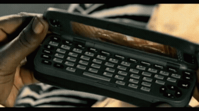 Person Holding Black Cell Phone With Keyboard GIF