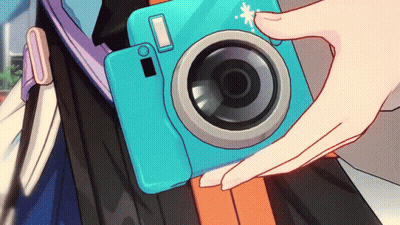 Person Holding Blue Camera With White Circle On Lens GIF